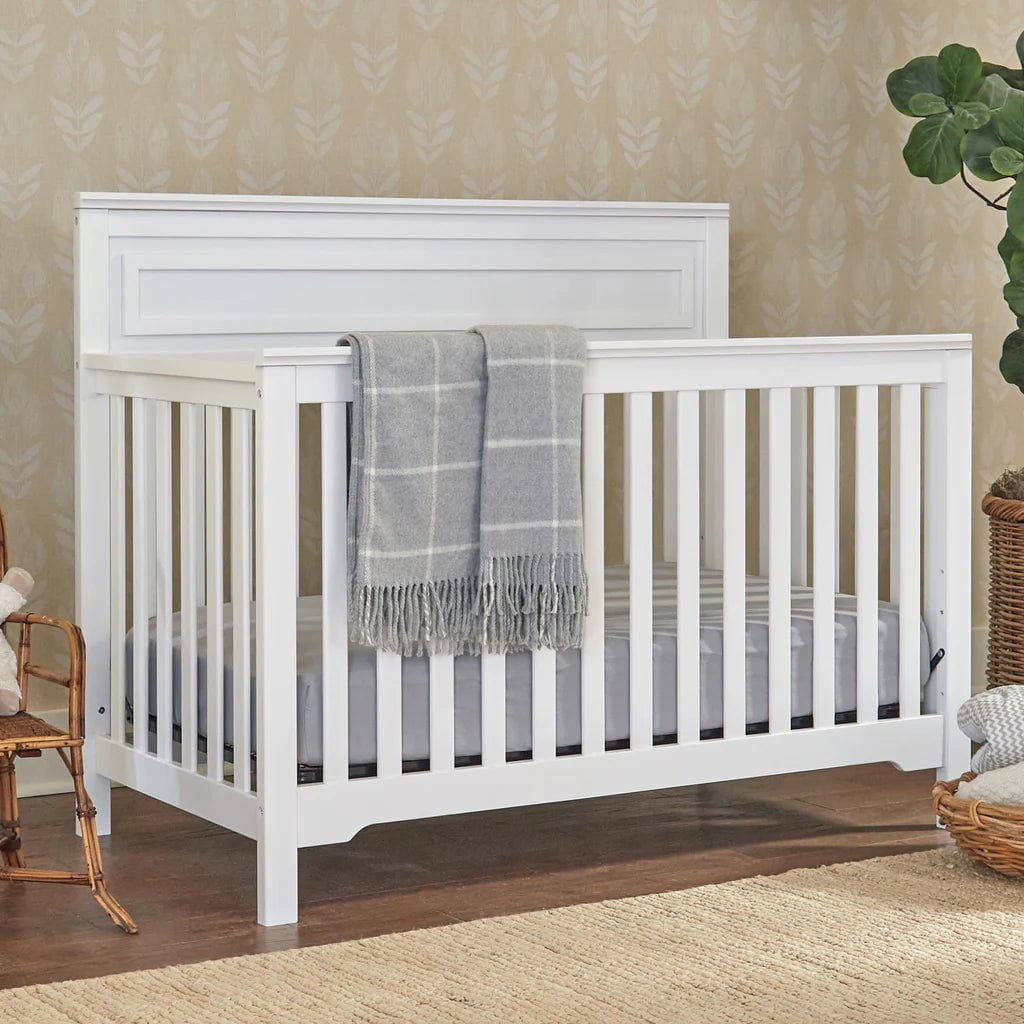 Natural wood convertible crib with toddler rail option, meeting Canadian safety needs for growing families.
