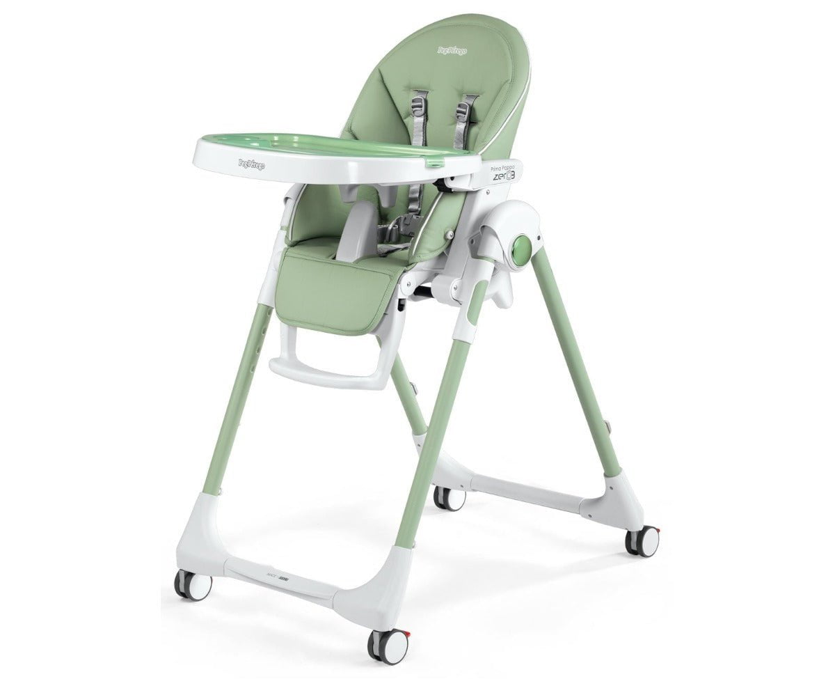 Green and white baby high chair with a removable tray, 5-point harness, and caster wheels.