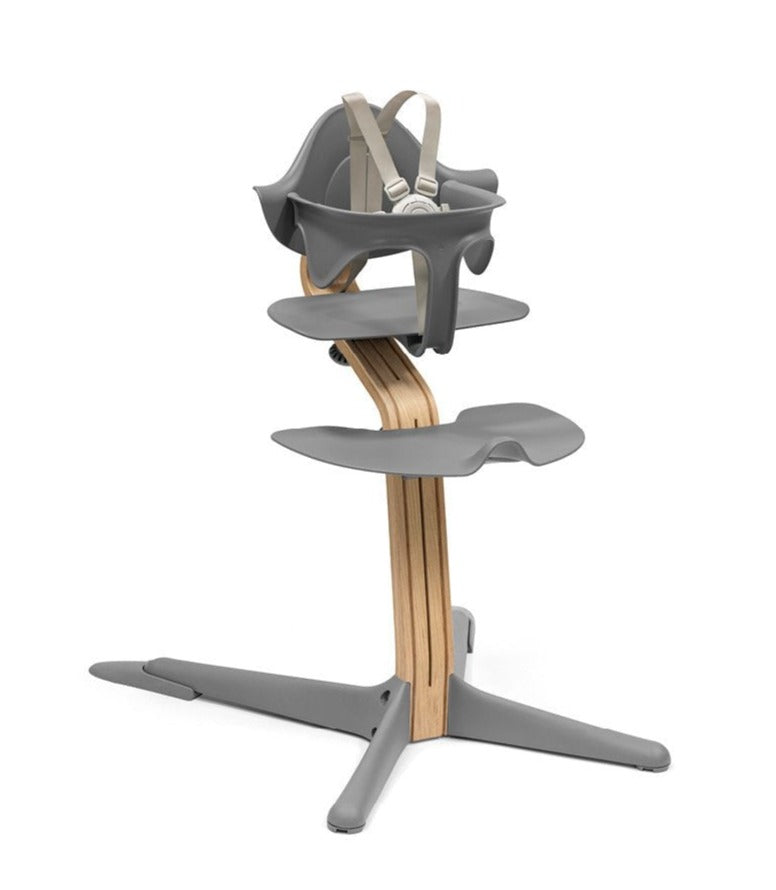 Stokke Tripp Trapp High Chair in gray with natural wooden accents, designed to grow with your child.